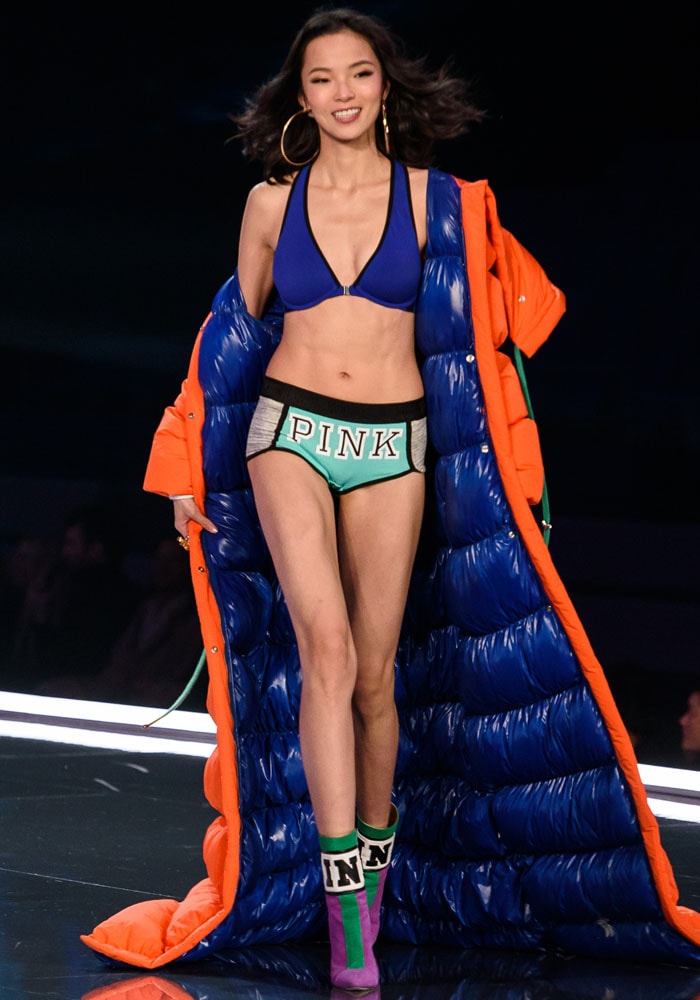 A floor-length puffer jacket envelopes a PINK lingerie-clad Xiao Wen