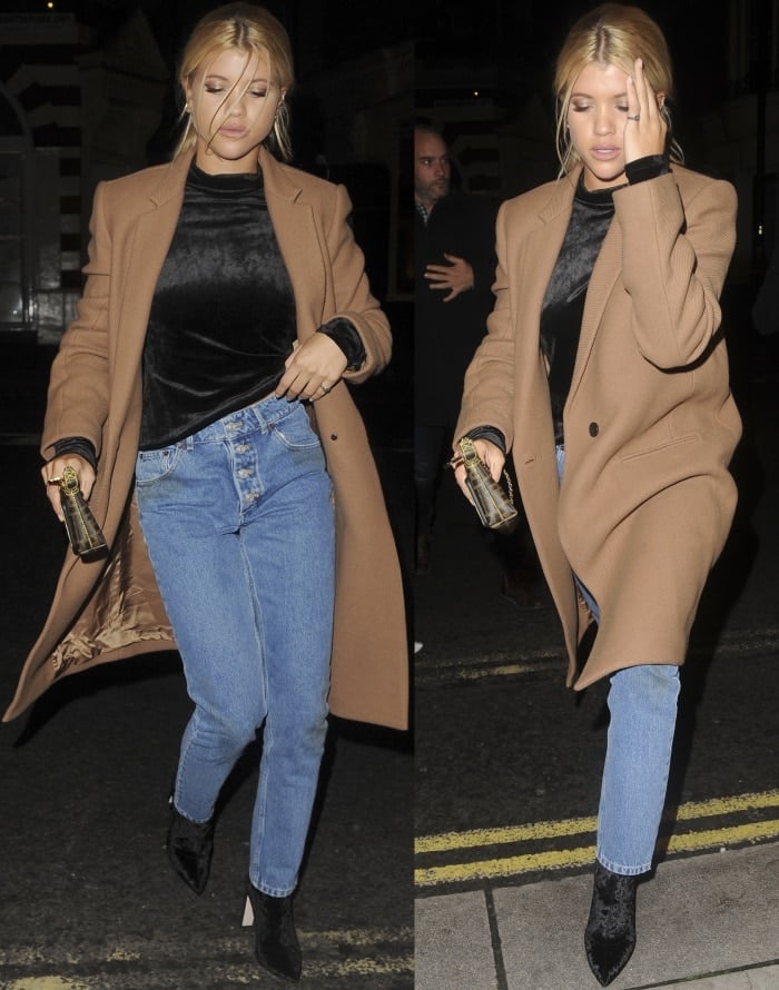 Sofia Richie wearing a Theory coat and turtleneck top, Balenciaga "Tube" jeans, and black velvet pointy-toe boots while out and about in London