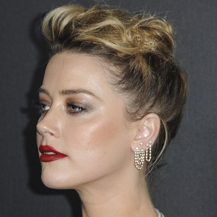 Amber Heard wearing mismatched earrings from Anita Ko