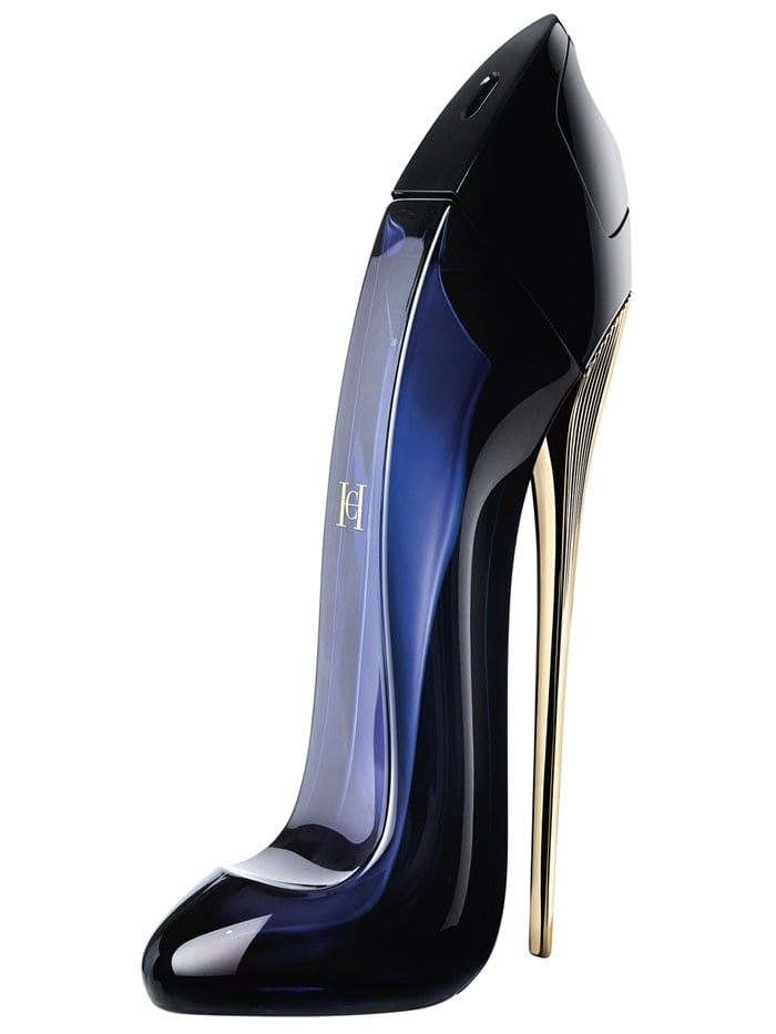 Carolina Herrera Good Girl fragrance in its shoe-shaped bottle standing on a gold stiletto heel.