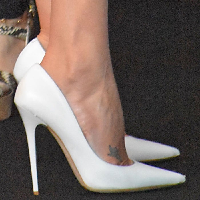 Charlize Theron wearing white pointy-toe pumps