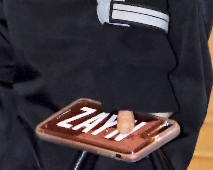 Gigi Hadid spotted at Tokyo International Airport with an iPhone case that has her boyfriend Zayn Malik's name on it
