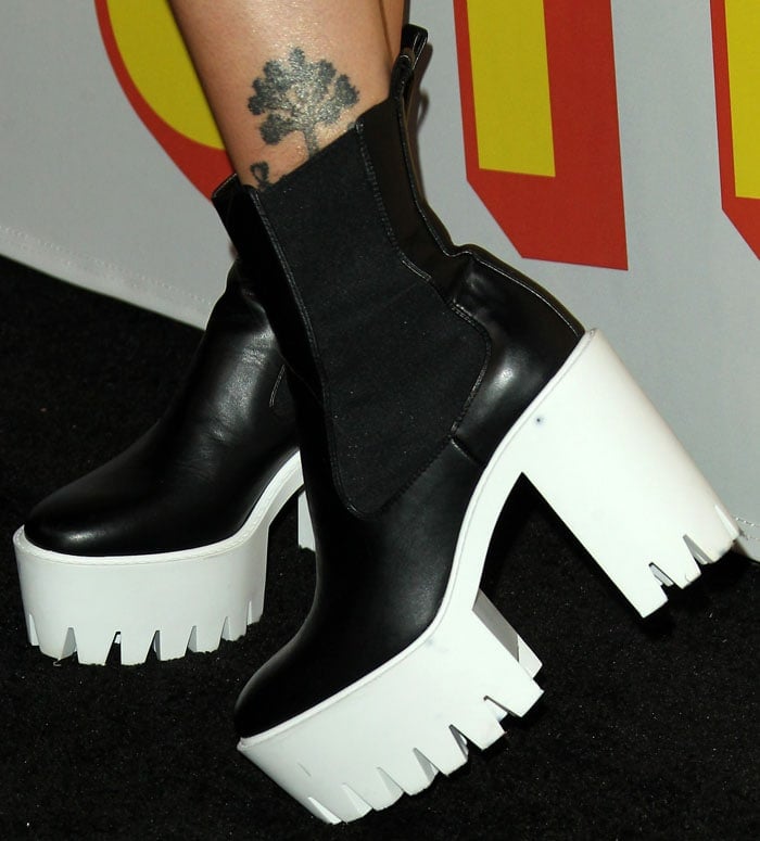 Paris Jackson wearing Stella McCartney 'Monster' faux-leather chelsea boots with chunky white rubber platform soles.