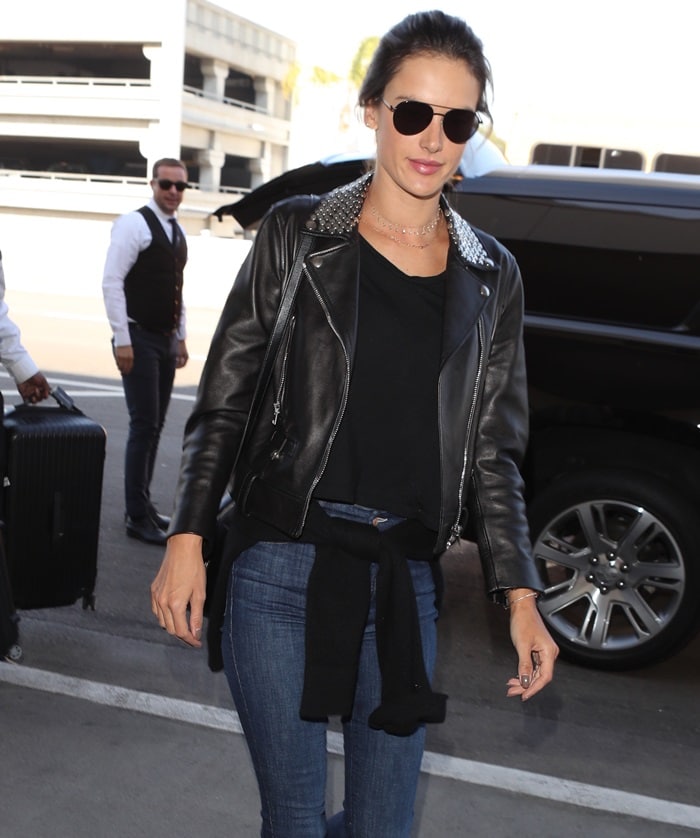 Alessandra Ambrosio wearing a leather motorcycle jacket with metal studs by Nour Hammour while jetting out of Los Angeles International Airport on February 2, 2018