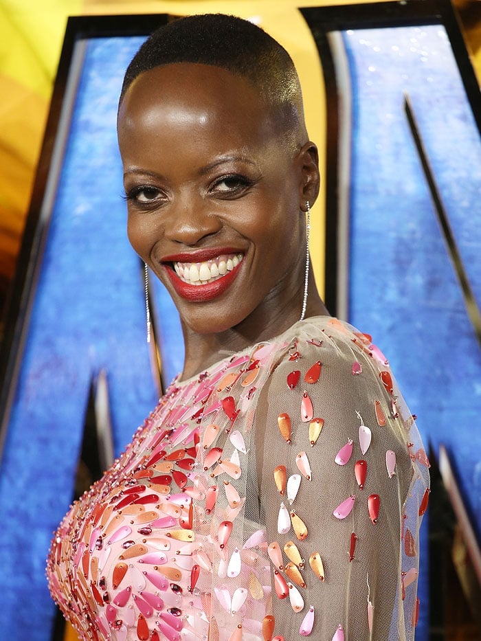 Florence Kasumba in dangling diamond-string earrings and a pink-and-red-sequined Jeny Packham gown.