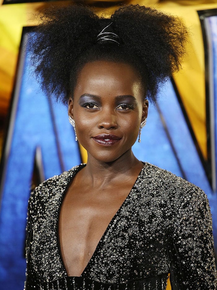 Lupita Nyong'o sparkling in 'Phenomena Glacier' earrings and a Balmain crystal-encrusted black-velvet gown.