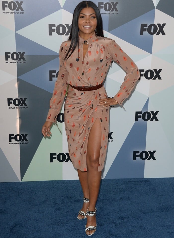 Taraji P. Henson in a feather-printed Altuzarra Fall 2018 dress featuring a collared neckline and wrap front bodice