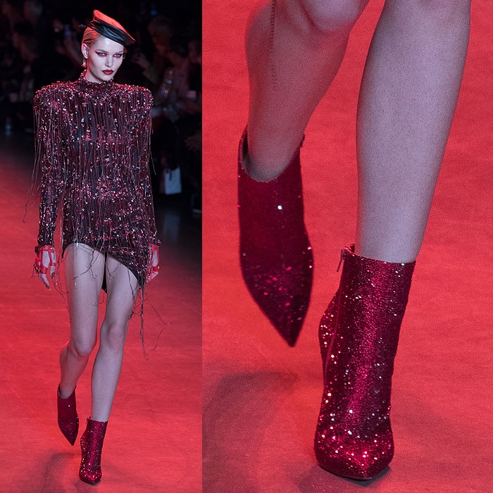 A model wearing Christian Louboutin for The Blonds red glitter ankle boots.