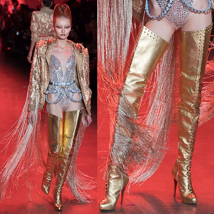 A model wearing a crystal-encrusted bodysuit with Christian Louboutin for The Blonds spike-studded gold thigh-high boots.