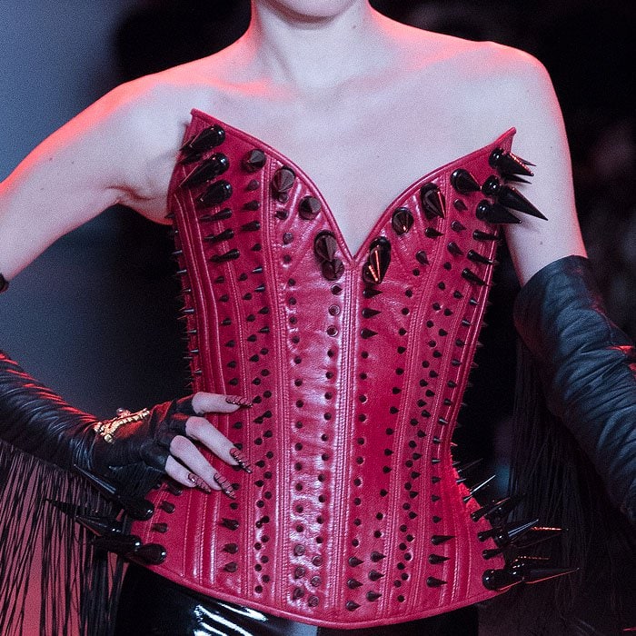 Red leather corset covered in black spikes