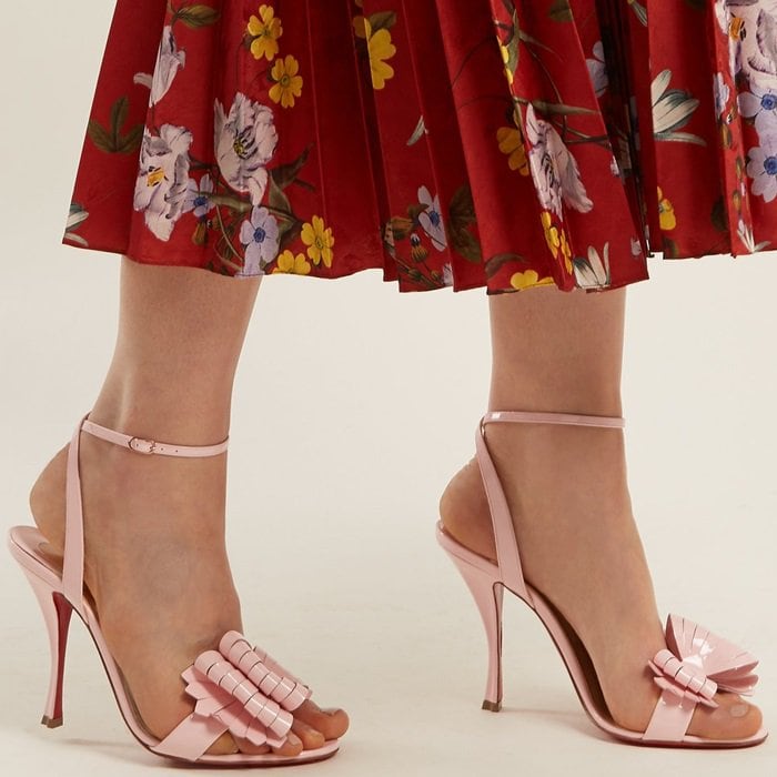 Christian Louboutin’s iconic bows are reinterpreted with a modern twist in the form of the laser-cut strips on these baby-pink Miss Valois sandals