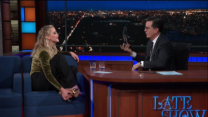 Jennifer Lawrence and Stephen Colbert kicking off their shoes.