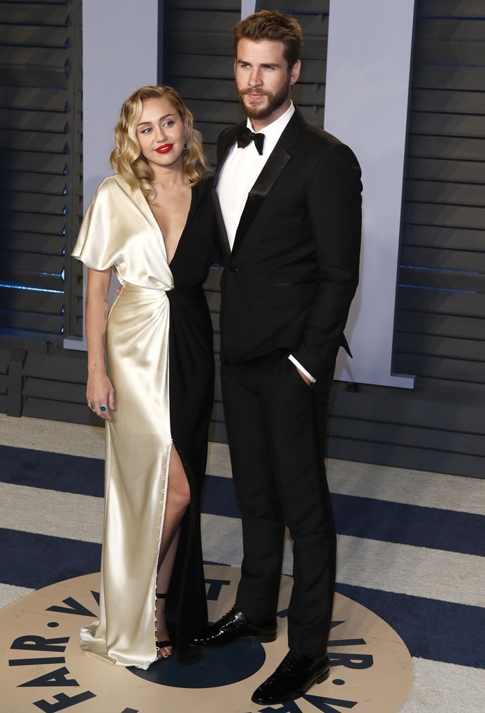 Miley Cyrus in a black and ivory silk crepe back satin v-neck column gown