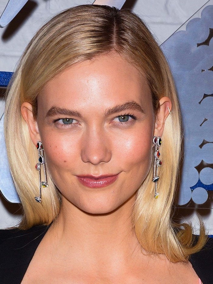 Karlie Kloss wearing Swarovski 'Luminous Fairy' clip earrings with multi-colored crystals and plated in rhodium.