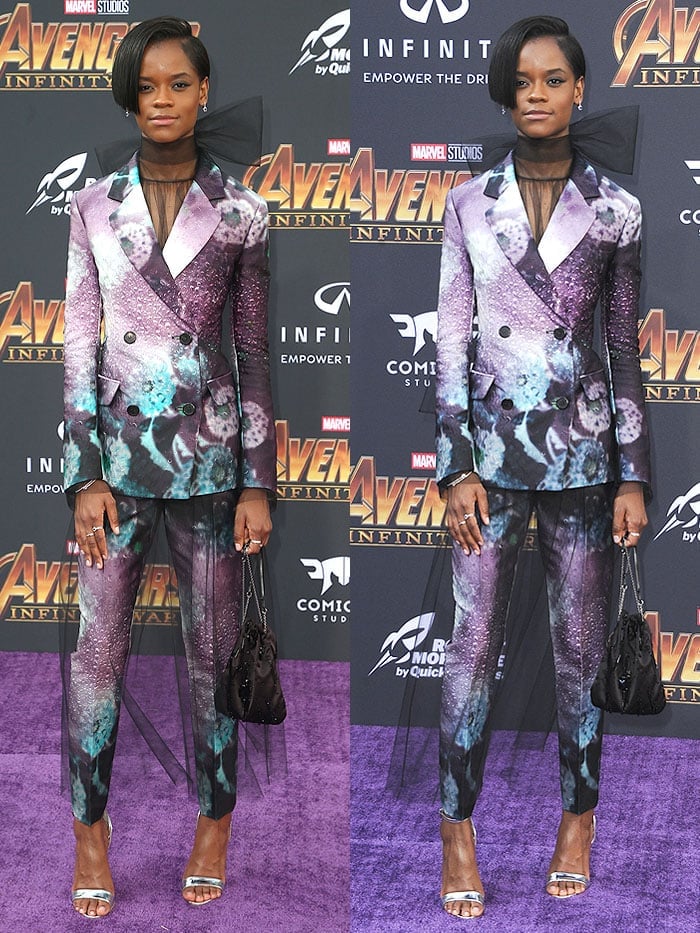 Letitia Wright in a custom Prada floral suit with silver layered-heel sandals and an embroidered satin handbag.