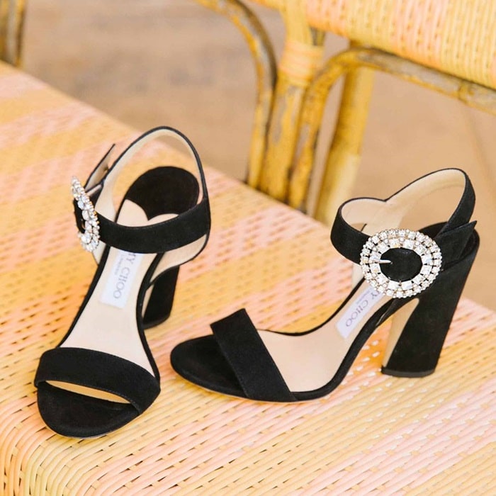 A dazzling crystal buckle brings showstopping glamour to a statement sandal crafted from buttery suede and perched on a sculptural heel to add leg-lengthening lift