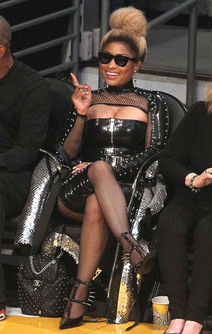Nicki Minaj in leather, studs, fishnets, and spiked t-strap pumps at a Lakers game.