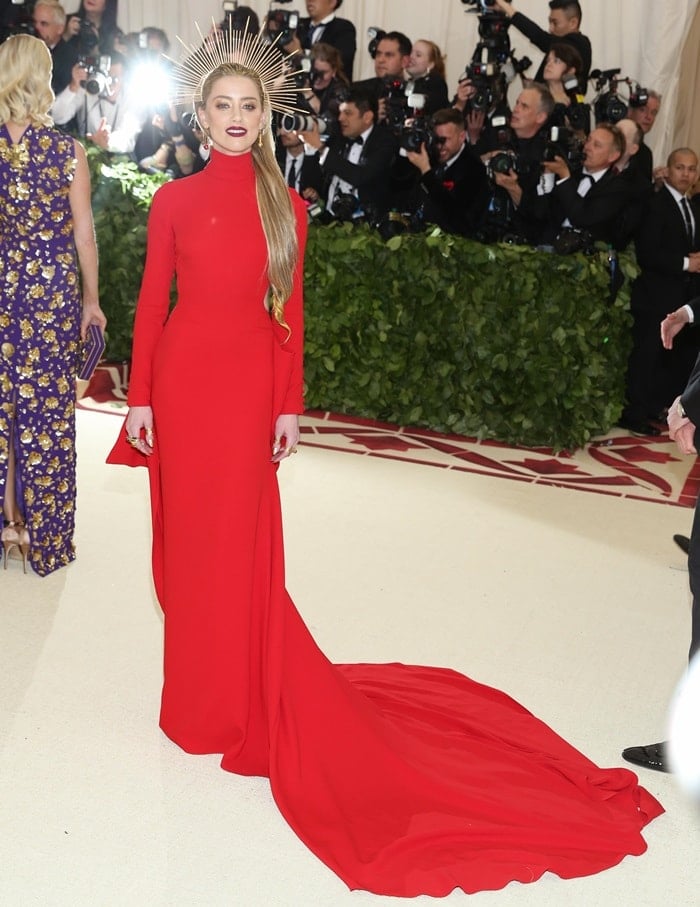 Amber Heard in a regal red long-sleeve Carolina Herrera gown