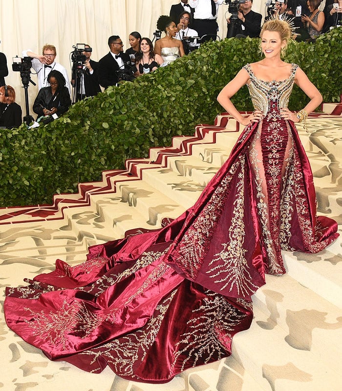 Blake Lively wearing Atelier Versace gold-and-red gown with a long train and custom Christian Louboutin sandals.