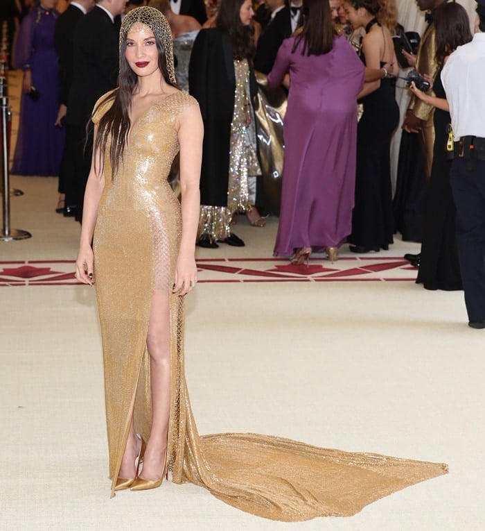 Olivia Munn shimmered in a sleeveless gold floor length dress from the H&M Conscious Collection