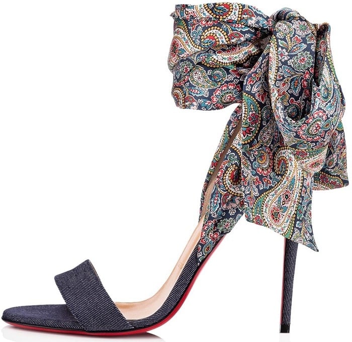 This colorful pair features an open toe and a leg lengthening, denim-covered stiletto heel