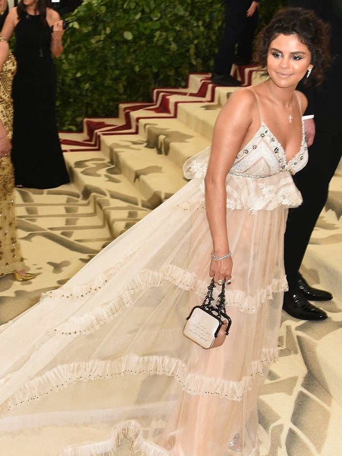 Selena Gomez's custom Coach gown and Coach 'Kisslock Frame' handbag at the 2018 Met Gala.
