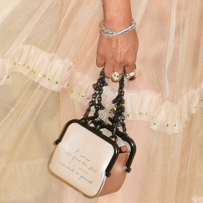Details of Selena Gomez's custom Coach 'Kisslock Frame' bag inscribed with Proverbs 31:30.