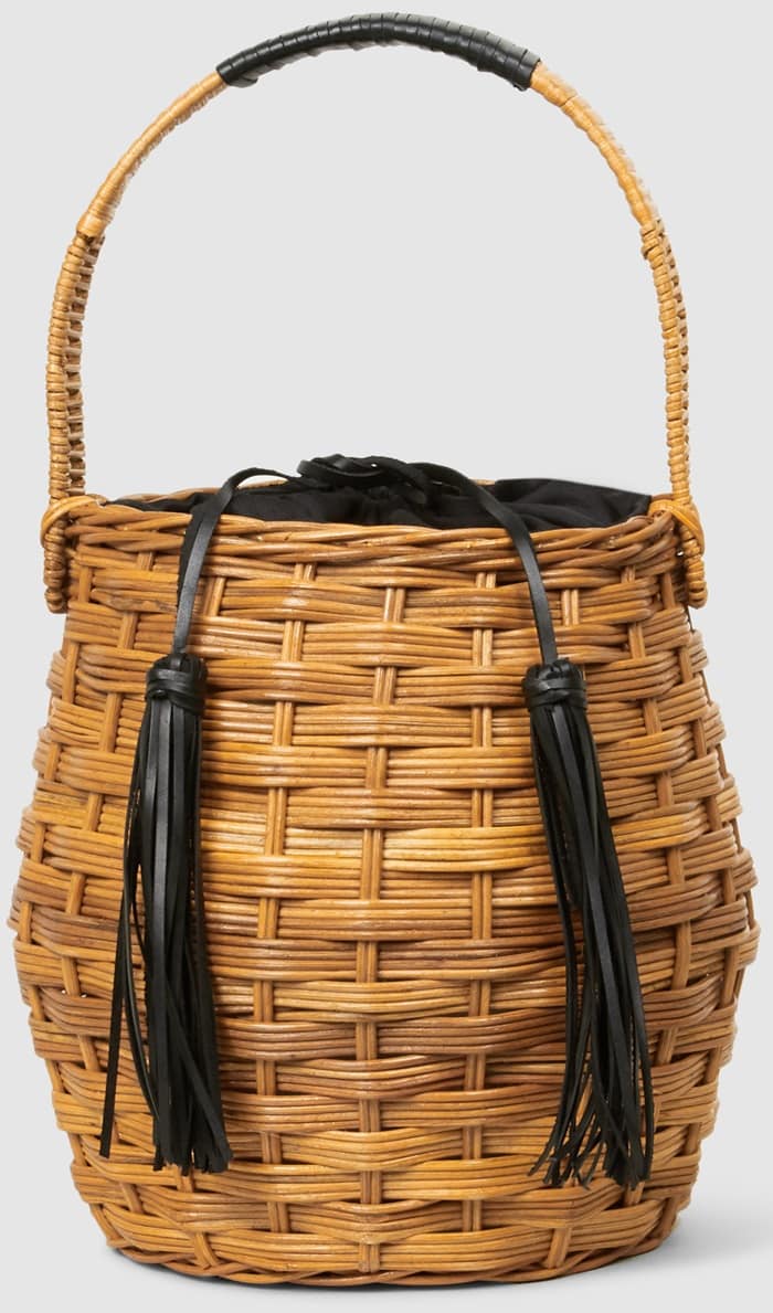 The Marais woven wicker bucket bag's curved silhouette is offset with tassels that double as a drawstring closure