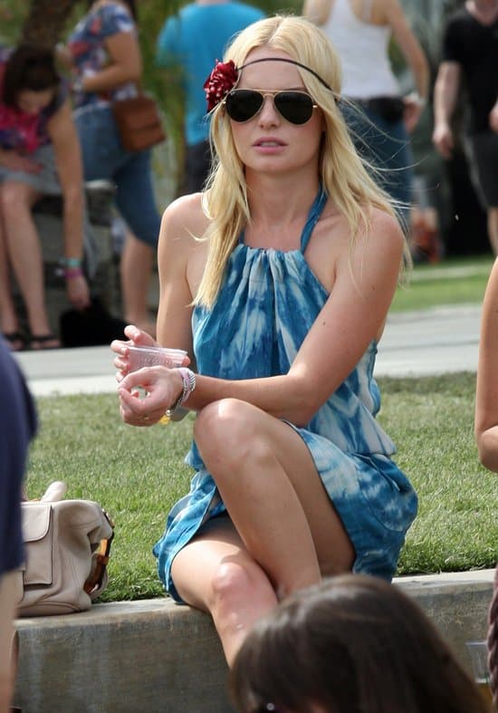 Kate Bosworth adds a floral touch with a headband, enhancing her '70s hippie look at Coachella