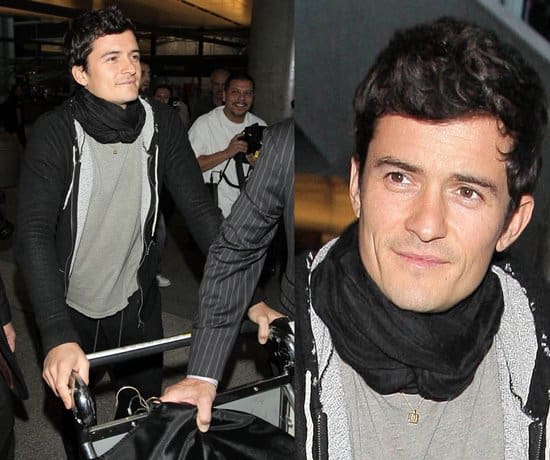This image, taken on November 30, 2009, at LAX Airport, showcases Orlando Bloom's practical yet fashionable use of a scarf, emphasizing his unique approach to comfort and style