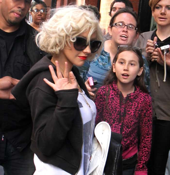 Christina Aguilera greets fans while arriving back at her hotel in Soho, New York, on May 8, 2010