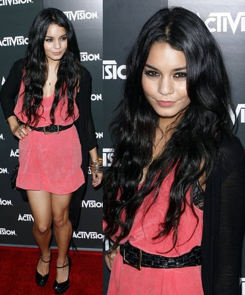 Vanessa Hudgens wears a tastefully short coral dress cinched with a black belt, layered with a sheer cardigan, and paired with sleek black platform heels at the Activision E3 2010 Preview Event held at Staples Center in Los Angeles on June 14, 2010