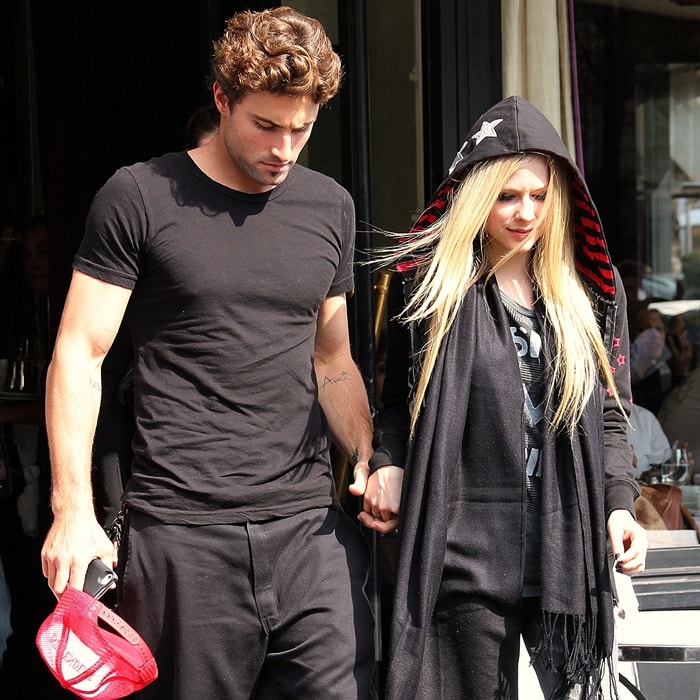 Brody Jenner shows off his ‘Avril’ tattoo while leaving L’Avenue restaurant hand-in-hand with Avril Lavigne, who rocks her signature punk style in a star-studded hood and graphic tee — Paris, September 16, 2011