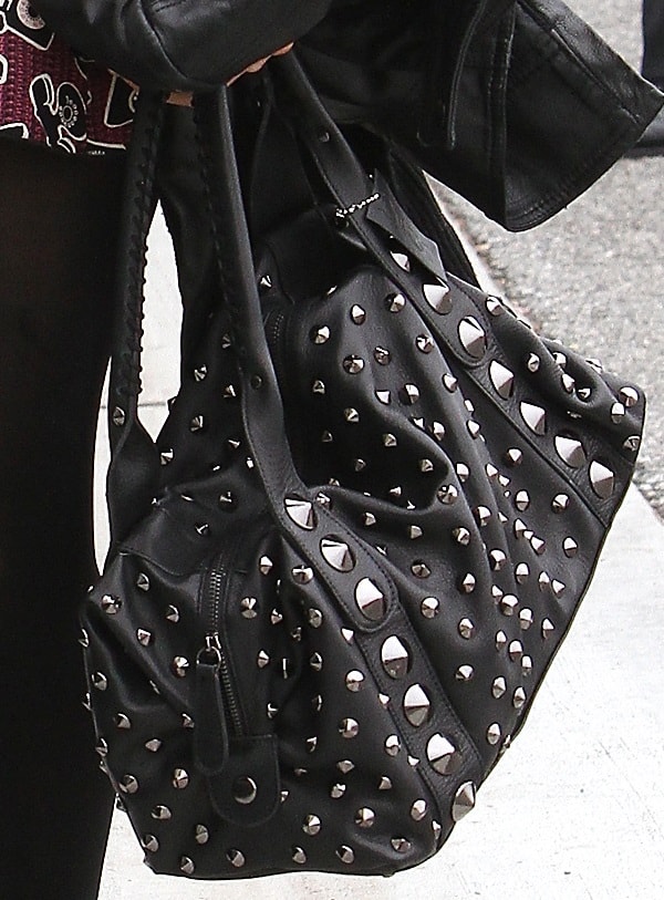 A closer look at Paris Hilton's edgy, studded handbag, perfectly complementing her mod chic outfit