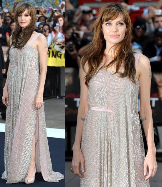 In a stunning silver dress, Angelina Jolie captivates at the UK premiere of 'Salt', Empire Leicester Square, London (August 16, 2010), embodying the film's dynamic spirit