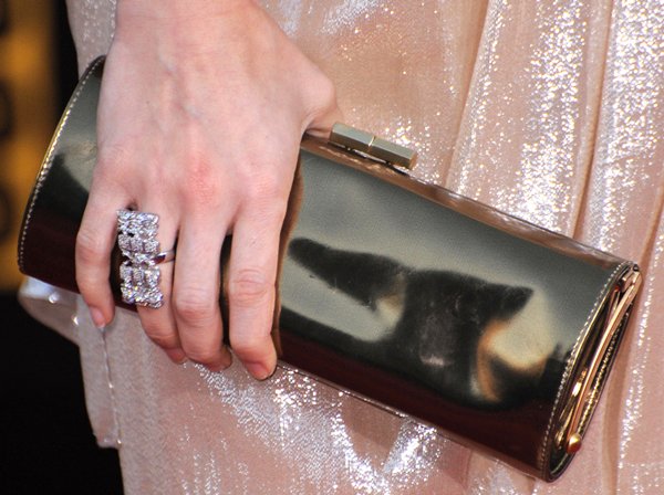 Carrie Underwood toting a tube metallic leather clutch