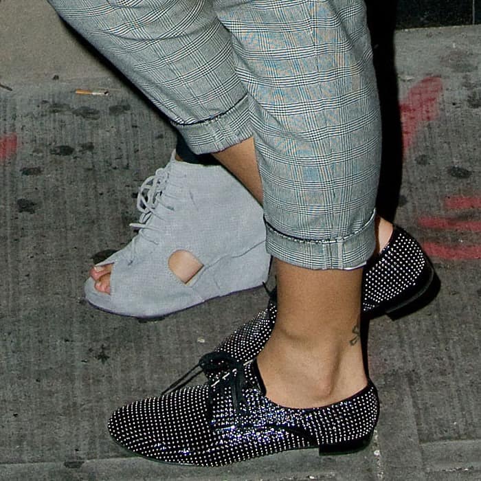 Rihanna added an edgy sparkle to her tailored look with black studded Miu Miu oxfords, perfectly contrasting her cropped Glen Plaid A.L.C. pants