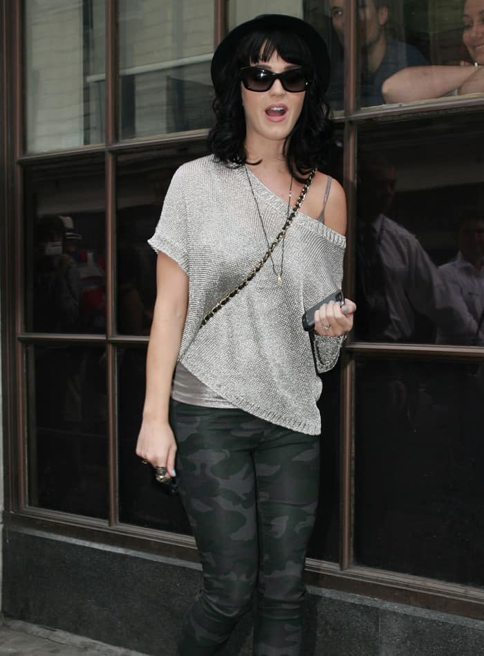 Katy Perry exudes chic urban style at the Radio One studios in London, wearing J Brand camouflage leggings paired with a sleek black fedora, June 24, 2010