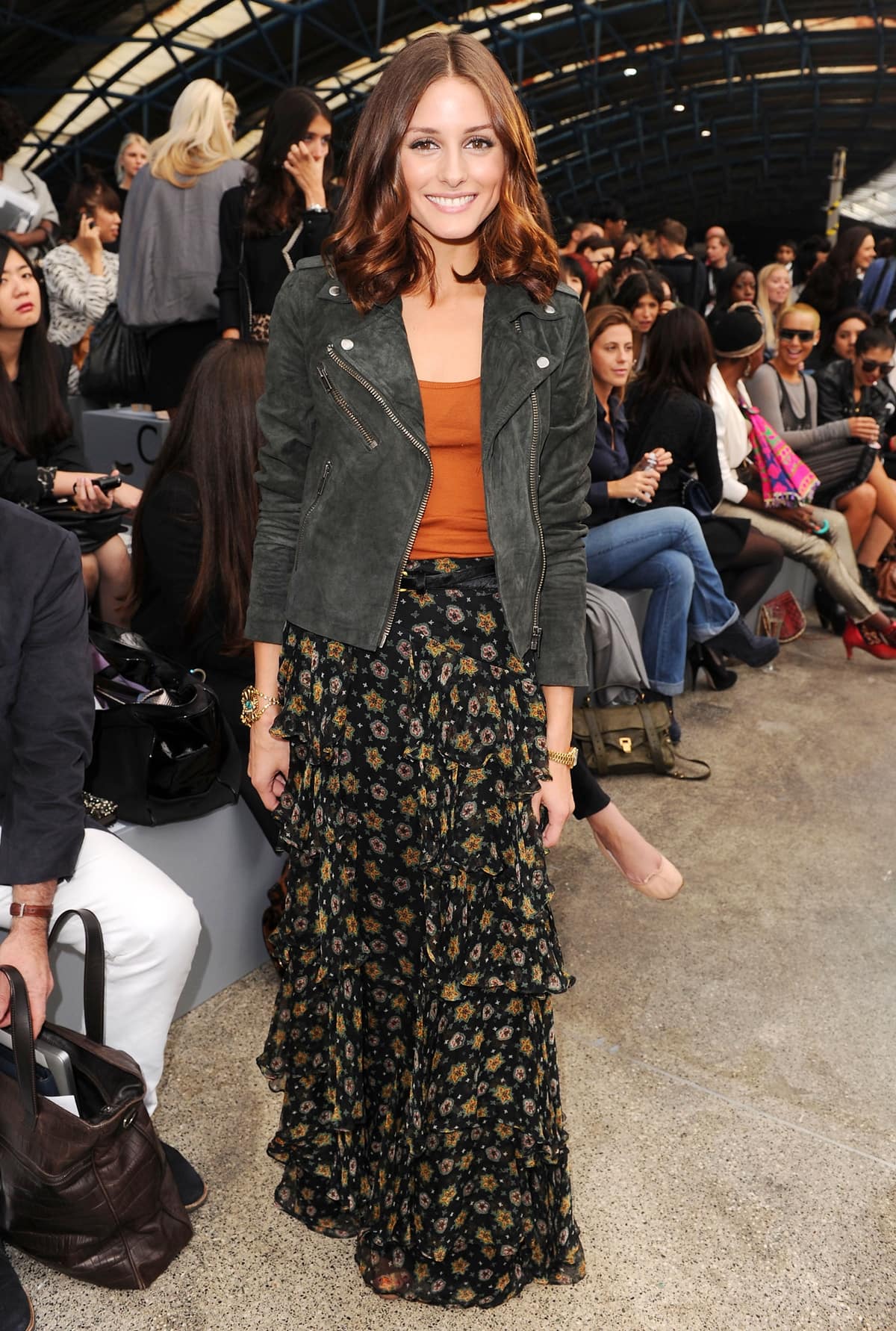 Olivia Palermo wears a suede biker jacket with a tier maxi skirt at the TopShop 'Unique' Spring/Summer 2011 show at Waterloo Station as part of London Fashion Week