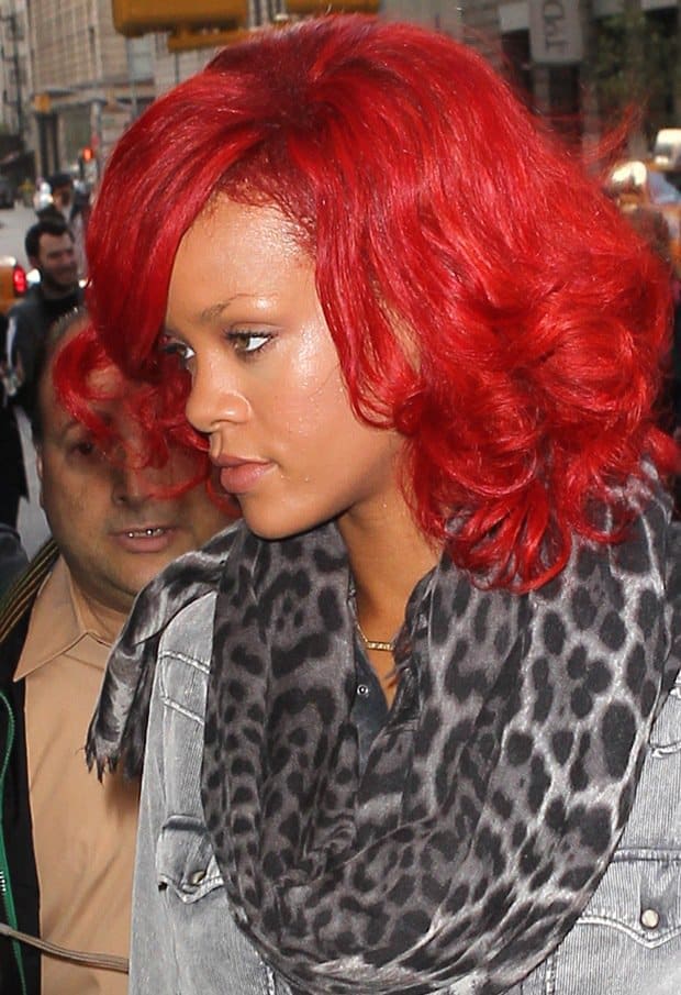 Rihanna turns heads in New York City, perfectly pairing her bold red hair with a leopard-print scarf by YSL