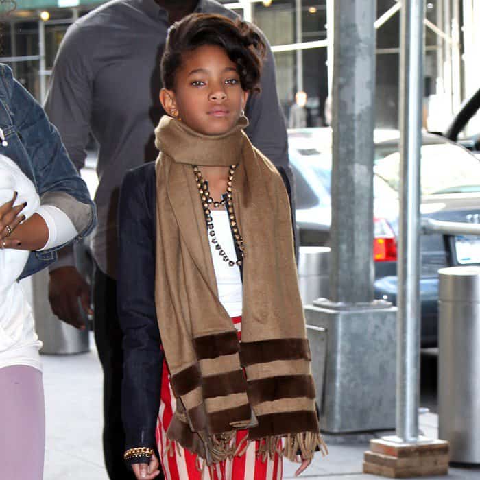 Willow Smith showcases her distinctive style with a luxurious camel scarf, adding a touch of sophistication to her youthful ensemble
