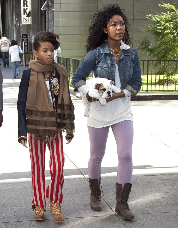 Captured on October 19, 2010, Willow Smith strolls through Manhattan with her dog, her outfit accented by a stylish camel scarf, embodying a unique and confident fashion sense