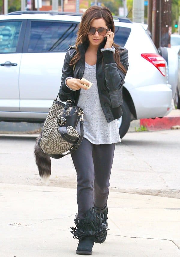 Ashley Tisdale channels effortless cool in a leather jacket and jeans, accessorized with chic Koolaburra boots and Ray-Ban aviators while arriving at a recording studio in Los Angeles on November 23, 2010