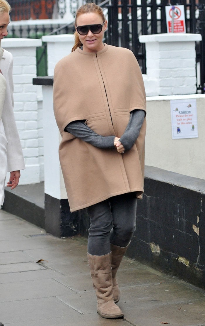 Stella McCartney exudes effortless sophistication in a chic camel cape and matching knee-high boots, a perfect blend of comfort and style for her London outing on November 18, 2010
