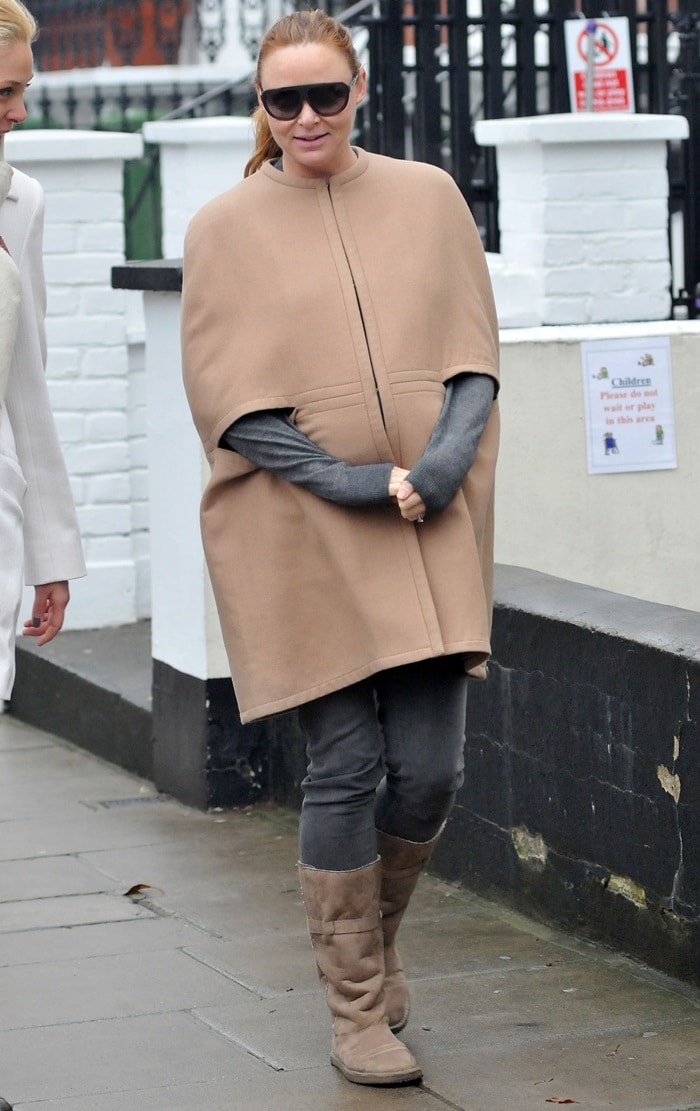 Stella McCartney holding her growing baby bump while out and about in London