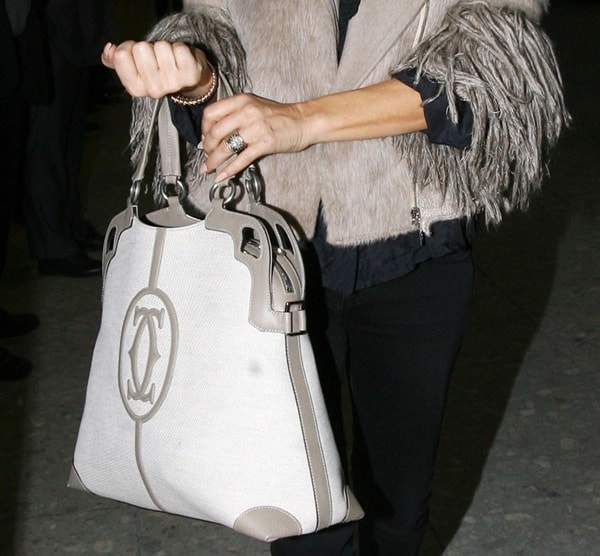 Fergie elegantly carries the Marcello De Cartier shopping bag in a versatile taupe shade, a perfect blend of luxury and functionality