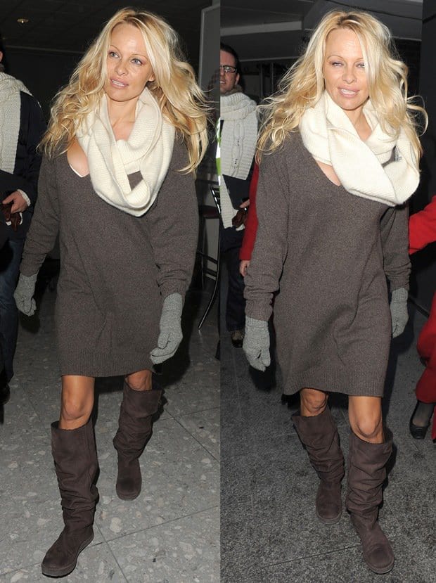 Pamela Anderson at Heathrow Airport on December 8, 2010, in England, where she is due to perform in the pantomime Aladdin in Liverpool over the festive season