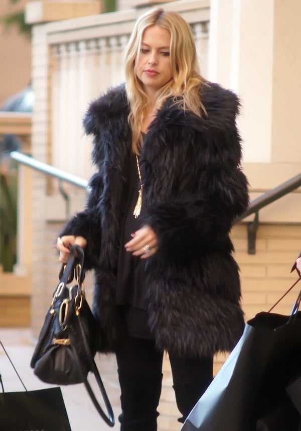 A pregnant Rachel Zoe wears her blonde hair down as she leaves Barneys of New York with her husband