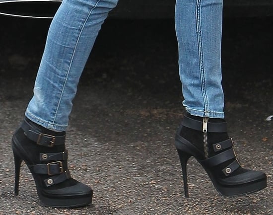 Cheryl Cole pairs her casual jeans with elegant black boots, adding a touch of glamour to her ensemble