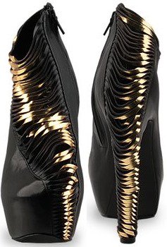 A closer look at the Iris van Herpen X United Nude ankle booties reveals their bold architectural silhouette and intricate gold detailing
